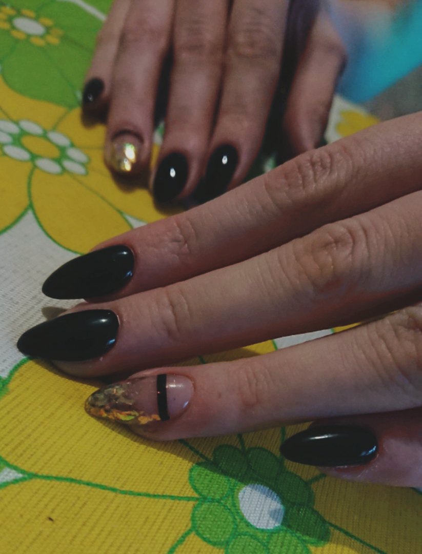 Маникюр с полосками и золотой фольгой в черном цвете на длинные ногти.