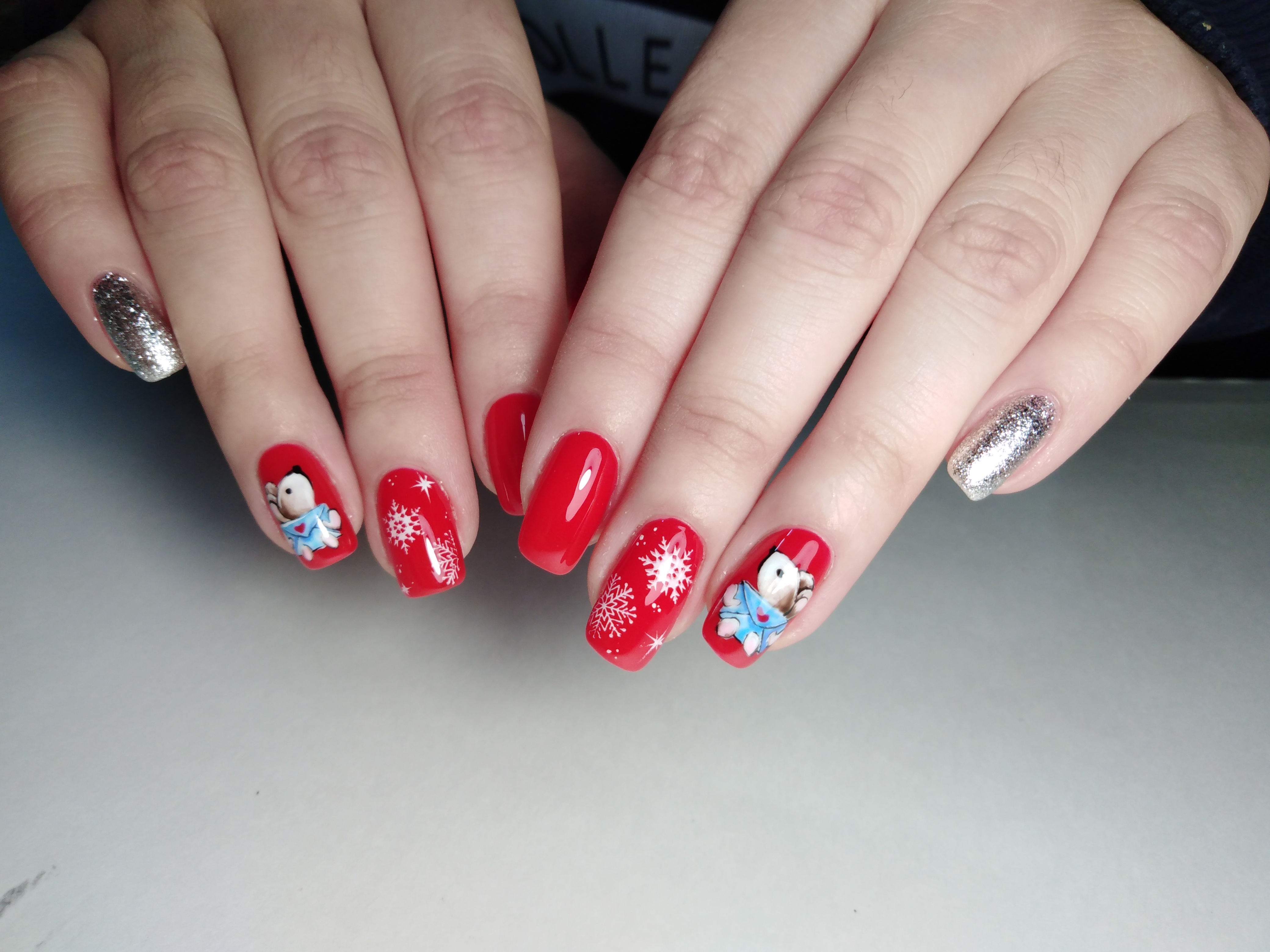 Маникюр в красном цвете с мультяшными слайдерами "мышки" и "снежинки" и серебряными блёстками.