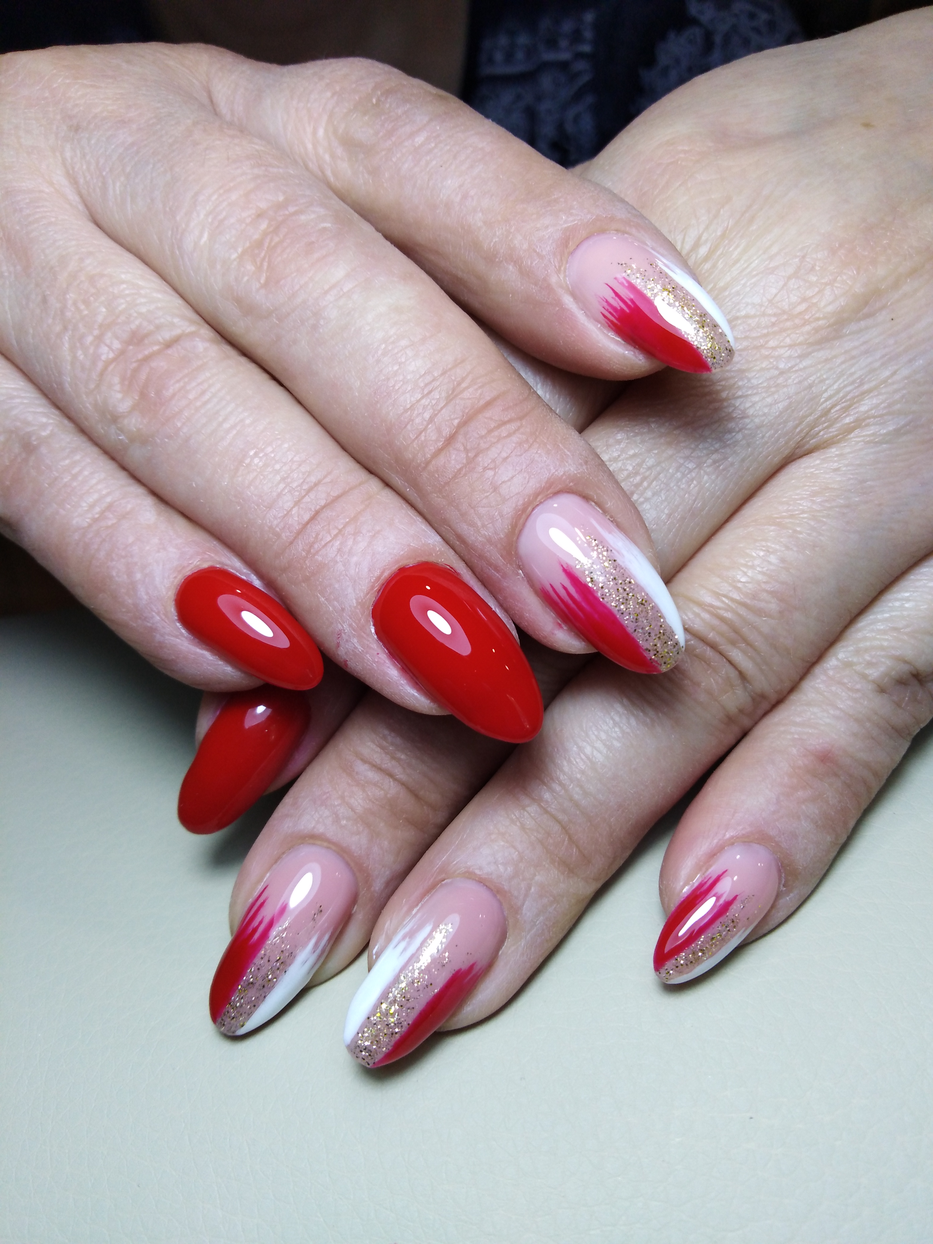 Маникюр с абстрактным рисунком и блестками в красном цвете на длинные ногти.