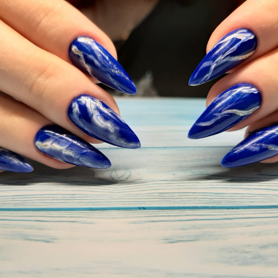 Маникюр с мраморным дизайном в синем цвете на длинные ногти.