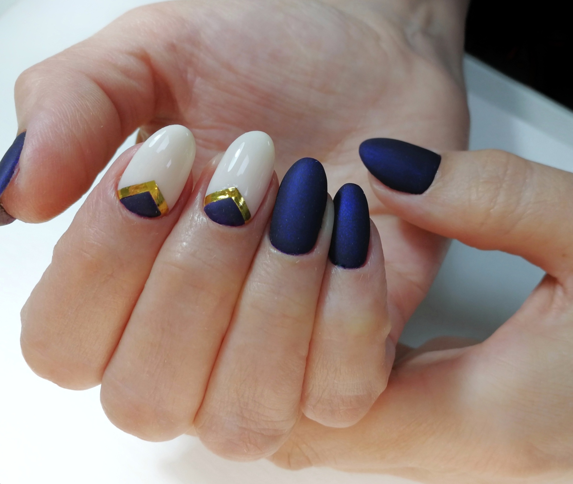 Матовый маникюр с лунным дизайном и золотыми полосками в темно-синем цвете на короткие ногти.